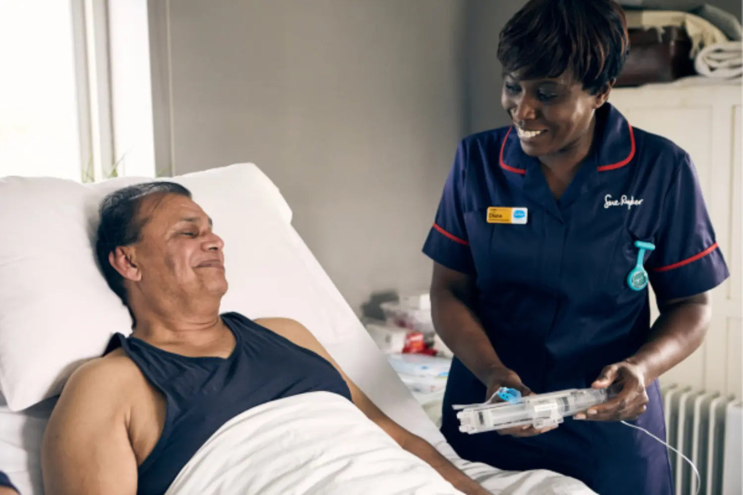 Nurse showing patient a syringe driver