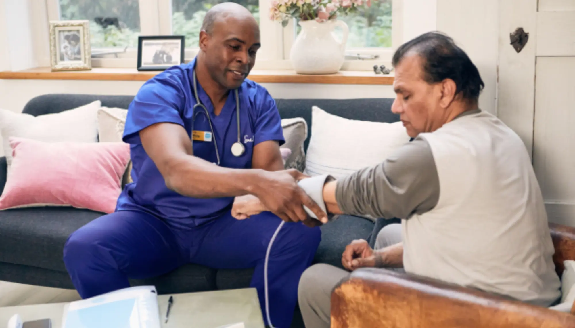 Healthcare professional taking patient blood pressure