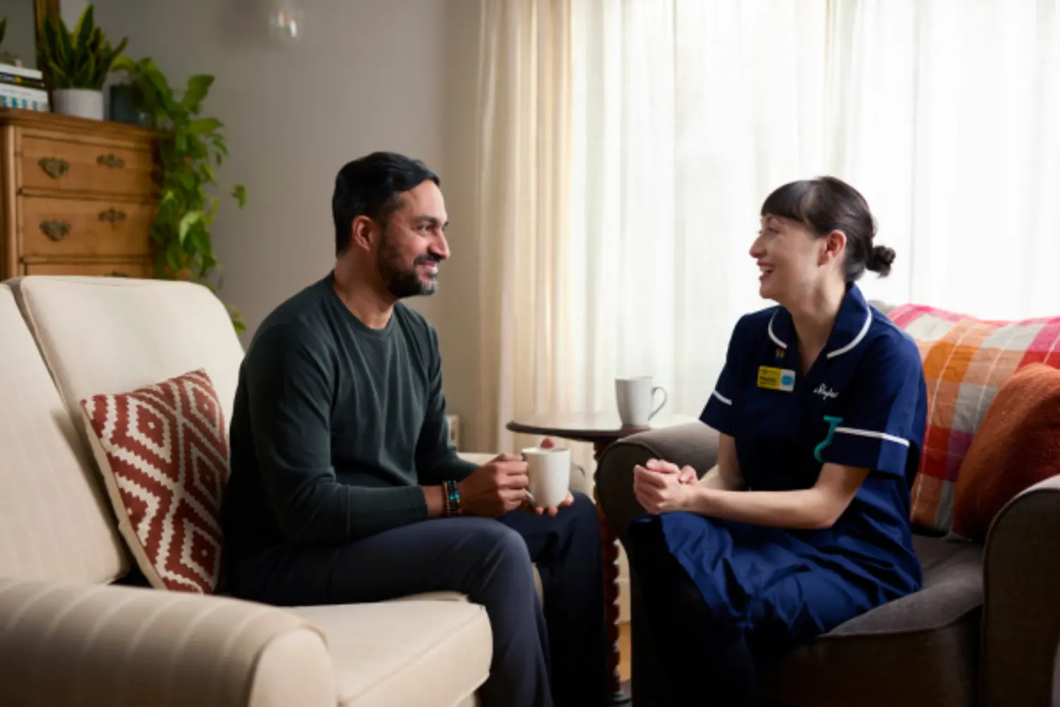 Nurse speaks with family member at home