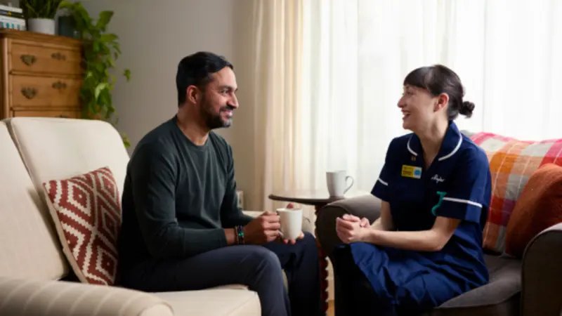 Nurse speaks with family member at home