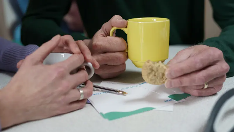 Supportive hands touching across a table