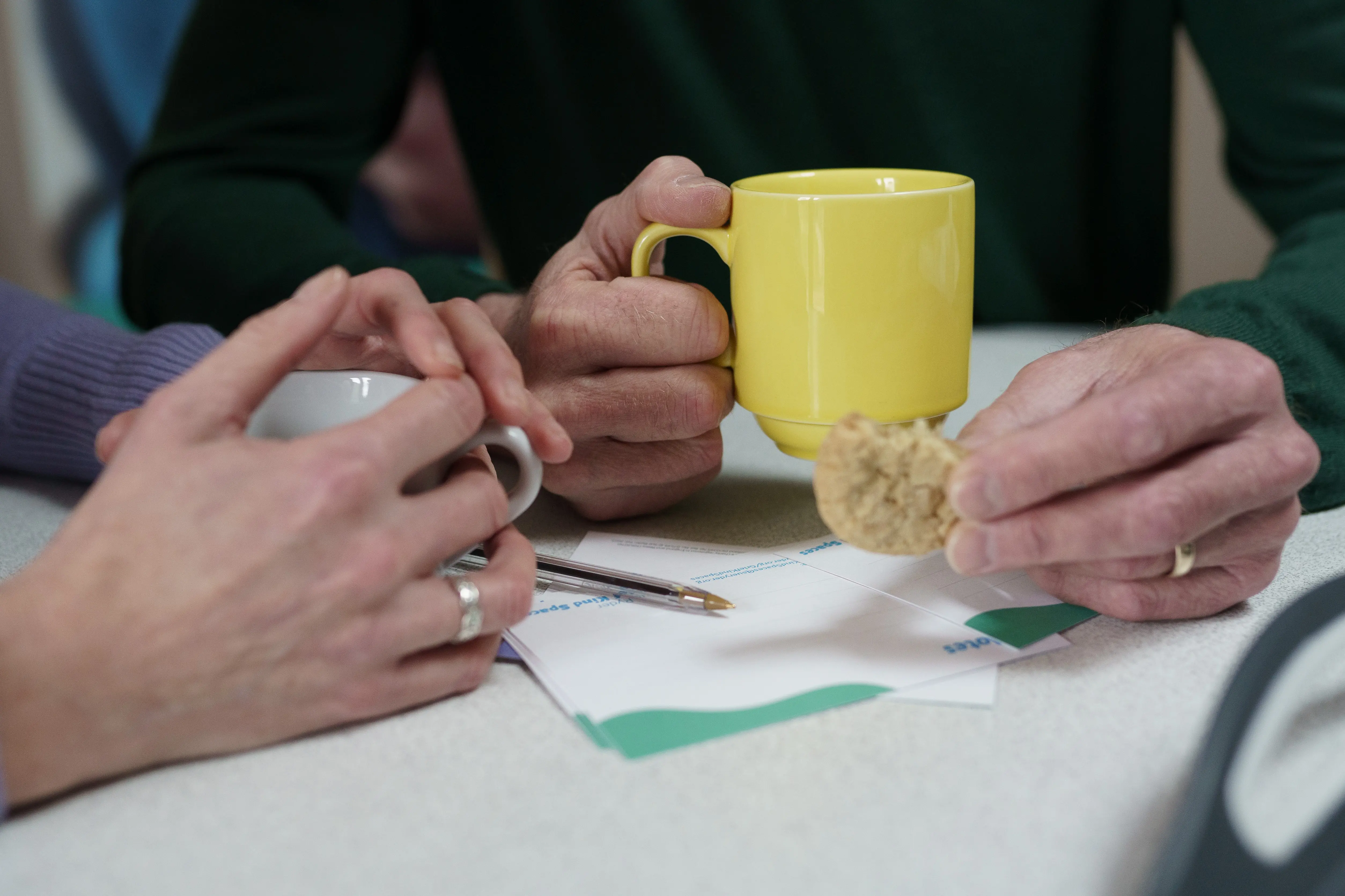 Supportive hands touching across a table